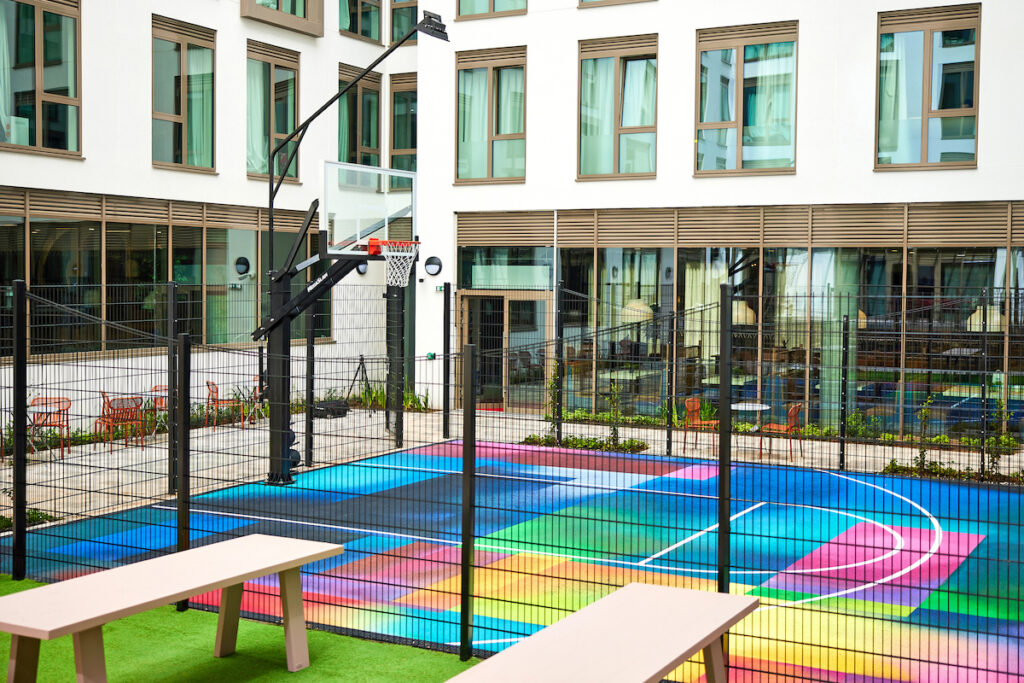 Basketball court adorned with a full mural by world-renowned graffiti artist Hazard One - aka Harriet Wood | PBSA News